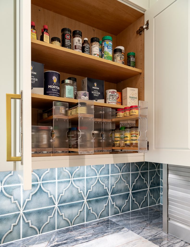 (pull-out spice rack cabinet): Custom cabinet design idea featuring a pull-out spice rack organizer, Kitchen Design Concepts Dallas kitchen Art deco style kitchen with an open floor plan featuring a multi-finish island